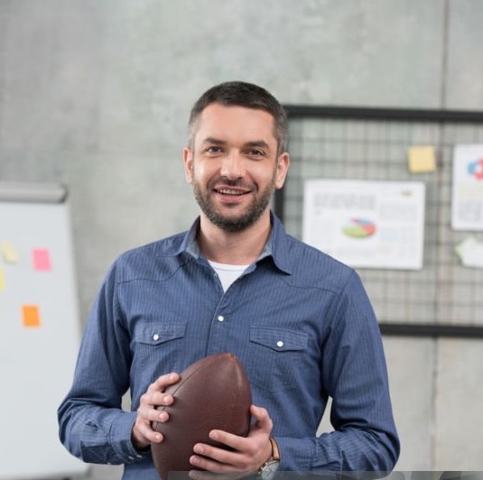 Chris, holding a football