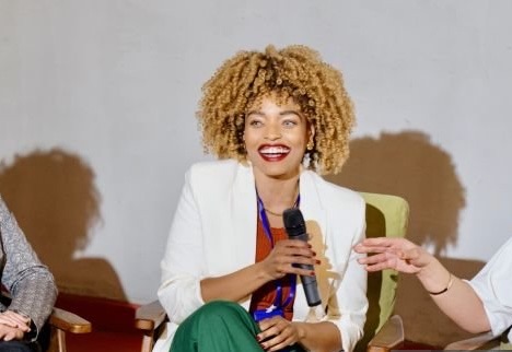 Taylor, speaking with a microphone
